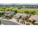 Aerial view of well-kept homes in neighborhood, showcasing desert landscaping and paved roads and proximity to grassy park space at 4239 W Reddie Loop, Phoenix, AZ 85083