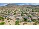 Scenic aerial view of a residential community with mountain backdrop and homes with swimming pools and solar panels at 4239 W Reddie Loop, Phoenix, AZ 85083