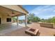 Spacious covered patio with ceiling fans overlooks the pool and fire pit at 4239 W Reddie Loop, Phoenix, AZ 85083
