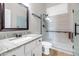 Bright bathroom boasts glass shower, granite counters, and bronze hardware at 4239 W Reddie Loop, Phoenix, AZ 85083