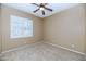 Bedroom with carpet, neutral colored walls, a ceiling fan and plantation shutters at 4239 W Reddie Loop, Phoenix, AZ 85083