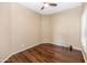 Bedroom with wood floors, a ceiling fan and plantation shutters for natural light at 4239 W Reddie Loop, Phoenix, AZ 85083