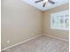 Bedroom with carpet, neutral colored walls, a ceiling fan and plantation shutters at 4239 W Reddie Loop, Phoenix, AZ 85083