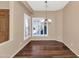 This dining room boasts wood floors, shutters, and a stylish chandelier at 4239 W Reddie Loop, Phoenix, AZ 85083