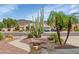 This home features a desert landscape, an attractive facade, and mountain views at 4239 W Reddie Loop, Phoenix, AZ 85083