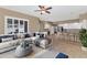 Bright living room with stylish furniture and decor open to the kitchen and breakfast bar at 4239 W Reddie Loop, Phoenix, AZ 85083