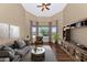 Cozy living room with a view of the outdoor pool, plush seating, and a ceiling fan at 4239 W Reddie Loop, Phoenix, AZ 85083