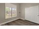 Cozy bedroom includes wood floors, a window with shutters, and sliding-door closet at 4338 E Hamblin Dr, Phoenix, AZ 85050