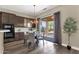 Stylish dining area with sliding glass door to backyard patio and modern chandelier at 4338 E Hamblin Dr, Phoenix, AZ 85050