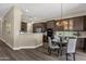 Elegant dining area with modern chandelier, and seamless flow to kitchen at 4338 E Hamblin Dr, Phoenix, AZ 85050