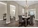Spacious dining room features elegant chandelier and dark wood floors at 4338 E Hamblin Dr, Phoenix, AZ 85050