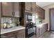 Gourmet kitchen showcases custom tile backsplash and a built-in oven at 4338 E Hamblin Dr, Phoenix, AZ 85050