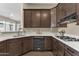 Modern kitchen features dark cabinets, white countertops, and stainless steel appliances at 4338 E Hamblin Dr, Phoenix, AZ 85050
