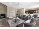 Cozy living room featuring a stone fireplace, stylish decor, and views of the dining area at 4338 E Hamblin Dr, Phoenix, AZ 85050