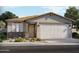 Charming single-story home featuring a two-car garage, stone accents, and a well-manicured front yard at 5561 S 246Th Ave, Buckeye, AZ 85326