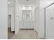 Bathroom features double vanity, glass shower, and neutral tile flooring at 5573 S 246Th Ave, Buckeye, AZ 85326