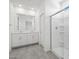Modern bathroom showcasing double vanity, a glass-enclosed shower, and neutral color palette at 5573 S 246Th Ave, Buckeye, AZ 85326
