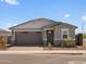 Charming single-story home with a well-maintained front yard and a two car garage at 5573 S 246Th Ave, Buckeye, AZ 85326