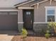Close up of front door with sidelight and brick accents on a single-story home at 5573 S 246Th Ave, Buckeye, AZ 85326