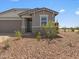 Attractive, low maintenance desert landscaping leads to the home's entryway at 5573 S 246Th Ave, Buckeye, AZ 85326
