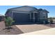 Charming single-story home featuring a brick driveway and a well-maintained, xeriscaped front yard at 5573 S 246Th Ave, Buckeye, AZ 85326