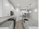 Bright kitchen with granite countertops, stainless steel appliances, and island with sink at 5573 S 246Th Ave, Buckeye, AZ 85326