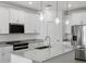 Bright kitchen with granite countertops, stainless steel appliances, and pendant lighting at 5573 S 246Th Ave, Buckeye, AZ 85326