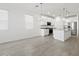 Bright, open kitchen features stainless appliances, white cabinetry, granite counters, and island with sink at 5573 S 246Th Ave, Buckeye, AZ 85326