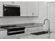 Close up of a modern kitchen with white cabinets and stainless steel appliances at 5573 S 246Th Ave, Buckeye, AZ 85326