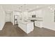 Bright kitchen features white cabinets, stainless steel appliances, and a large island with granite countertops at 5573 S 246Th Ave, Buckeye, AZ 85326