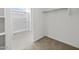 Bright walk-in closet with carpet flooring, closet organizer, and attached bathroom featuring a glass-enclosed shower at 5573 S 246Th Ave, Buckeye, AZ 85326