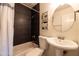 Well-lit bathroom showcasing the shower, modern tiles, vanity, and stylish decor at 6012 W Flower St, Phoenix, AZ 85033