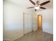 Spacious bedroom with ceiling fan, and closet with sliding doors at 6012 W Flower St, Phoenix, AZ 85033
