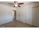 Bedroom with fan, tile floor and closet doors at 6012 W Flower St, Phoenix, AZ 85033