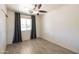 Well lit bedroom with light floors, and a view of neighborhood at 6012 W Flower St, Phoenix, AZ 85033