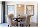 Cozy dining room with round wood table, upholstered chairs, and modern artwork at 6012 W Flower St, Phoenix, AZ 85033
