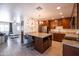 Open concept kitchen with island, stainless appliances, and view into living area at 6012 W Flower St, Phoenix, AZ 85033