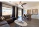 Open concept living area featuring a sofa, dining table, and sliding glass doors to patio at 6012 W Flower St, Phoenix, AZ 85033