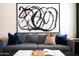 Comfortable gray sofa with colorful throw pillows and modern wall art at 6012 W Flower St, Phoenix, AZ 85033