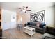 Bright living room featuring tile floors, a gray sofa, and stylish decor at 6012 W Flower St, Phoenix, AZ 85033