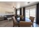 Open-concept living space with dining area, sofa, and sliding glass doors to patio at 6012 W Flower St, Phoenix, AZ 85033