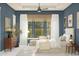 Charming bedroom featuring beautiful blue walls, a ceiling fan and ample natural light from the window at 667 E Brown Way, San Tan Valley, AZ 85140