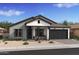 Charming single-story home featuring a gray exterior, dark accents, and a welcoming front porch with rocking chairs at 667 E Brown Way, San Tan Valley, AZ 85140