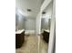 Bathroom featuring double sinks and vanity, and a shower-tub combo with tile surround at 7126 N 19Th Ave # 224, Phoenix, AZ 85021