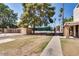 Exterior view of fenced-in community tennis court next to mature trees and landscaping at 7126 N 19Th Ave # 224, Phoenix, AZ 85021