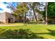 Charming townhomes with lush green lawn and mature trees create a serene and inviting community atmosphere at 7126 N 19Th Ave # 224, Phoenix, AZ 85021