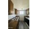 Functional kitchen features wooden cabinets and stainless steel sink at 7126 N 19Th Ave # 224, Phoenix, AZ 85021