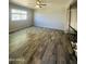 Bright living room featuring stylish wood-look flooring and a modern ceiling fan at 7126 N 19Th Ave # 224, Phoenix, AZ 85021