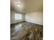 Open living room features wood-look flooring and a large window at 7126 N 19Th Ave # 224, Phoenix, AZ 85021