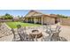 Secluded backyard oasis offers a covered patio, artificial grass lawn, and cozy fire pit area at 7253 S Terrace Rd, Tempe, AZ 85283